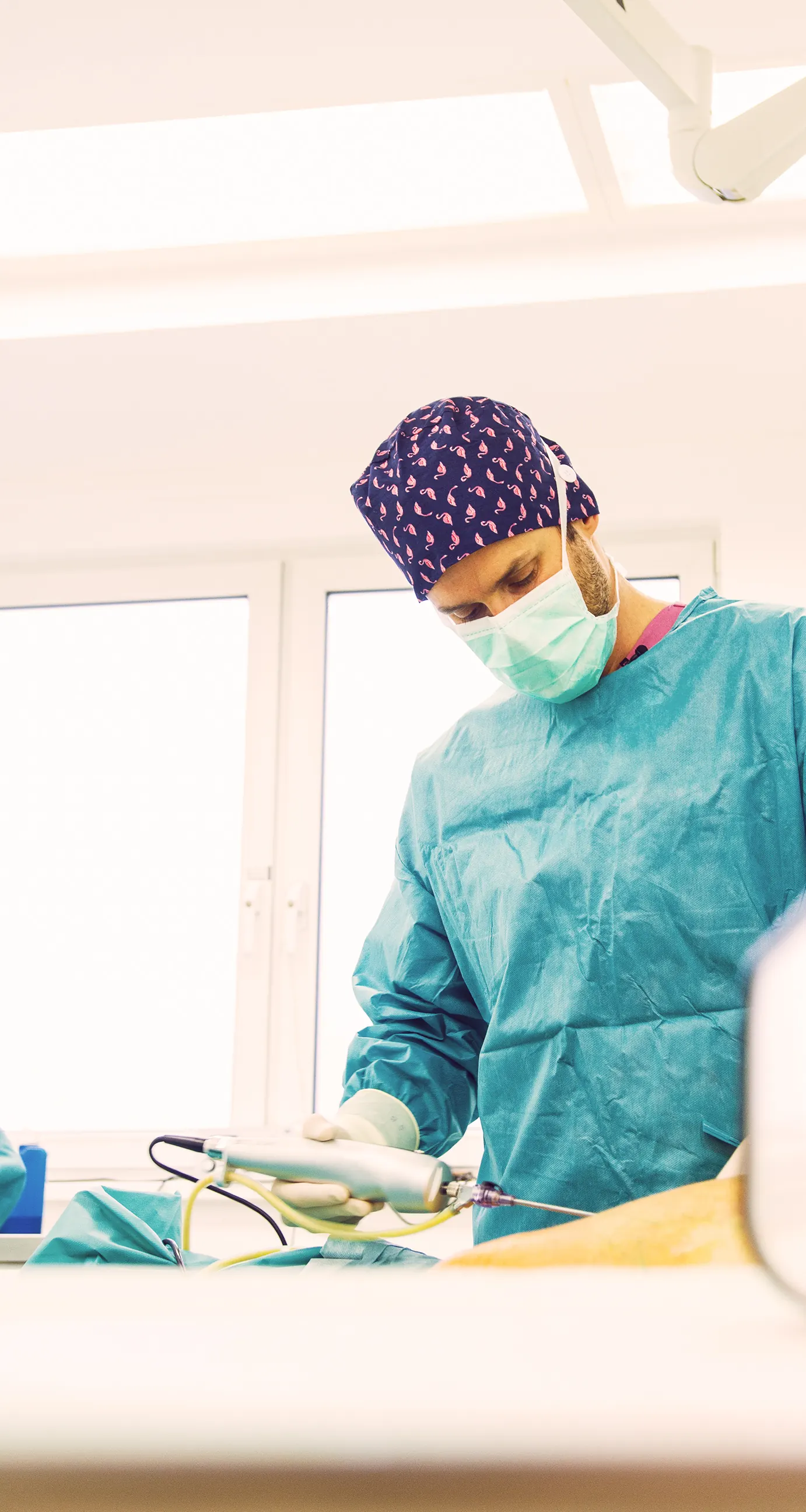 Surgeon performing liposuction in the operating theatre